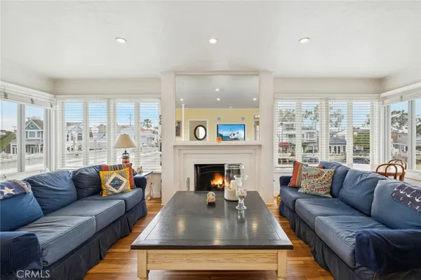 a living room with furniture fireplace and a large window