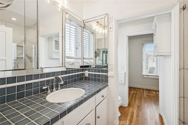 a bathroom with a shower sink and mirror