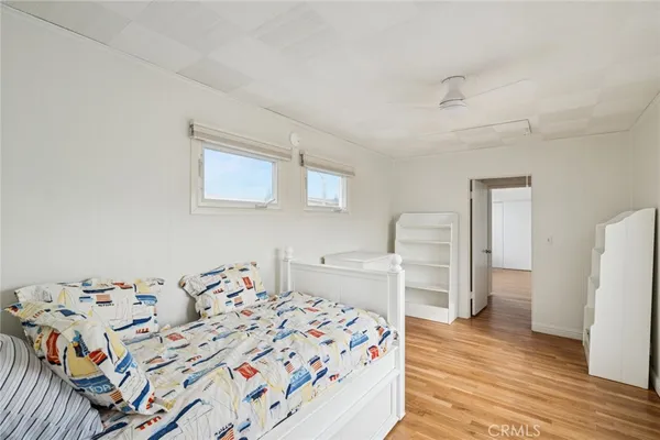a view of a hallway with closet and wooden floor