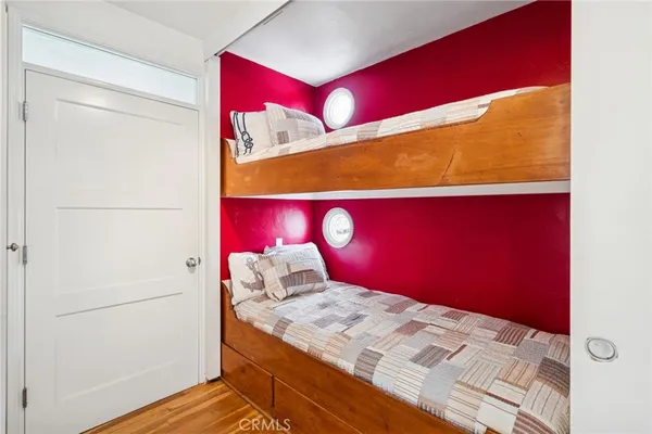 a bedroom with a bed and a potted plant