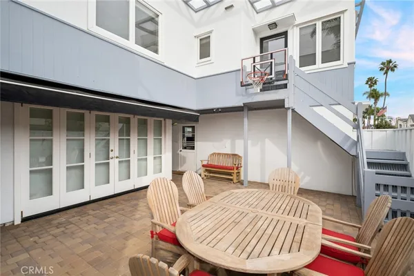 a front view of a house with swimming pool and outdoor seating