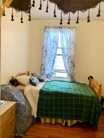 a bedroom with a bed and a window