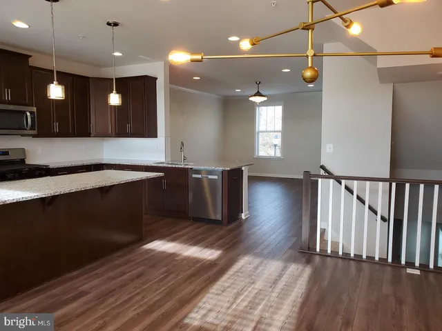 a view of a kitchen with a sink and a wooden floor