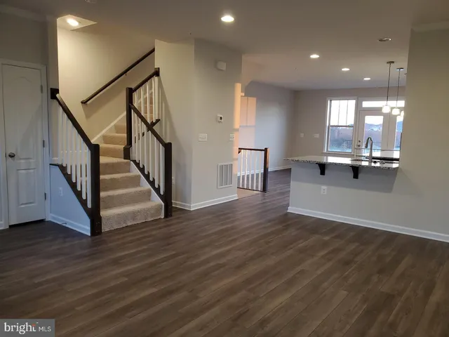 a view of a kitchen with wooden floor and a kitchen