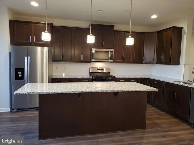 a kitchen with a stove a sink and a refrigerator