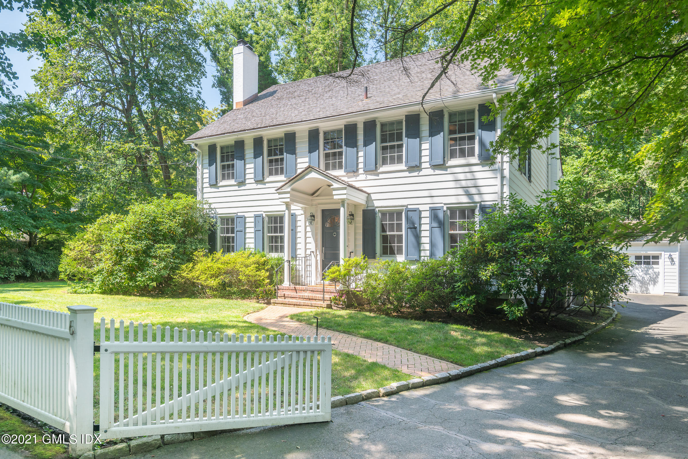 6 Park Avenue Greenwich, CT 06830 - Photo 1 of 24 a front view of a house with a garden