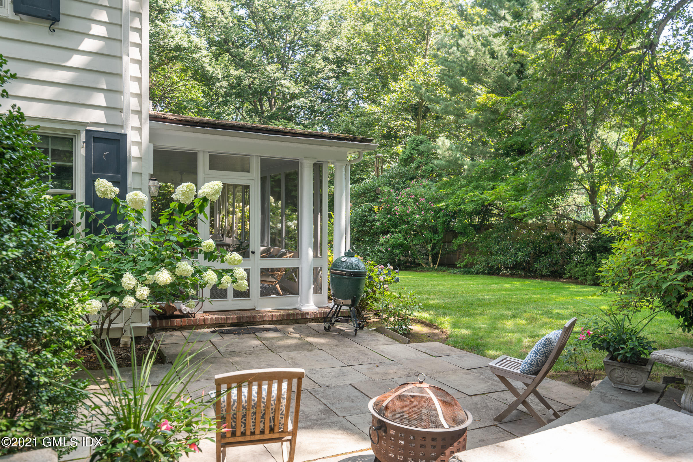 6 Park Avenue Greenwich, CT 06830 - Photo 17 of 24 a view of a patio with table and chairs potted plants and floor to ceiling window