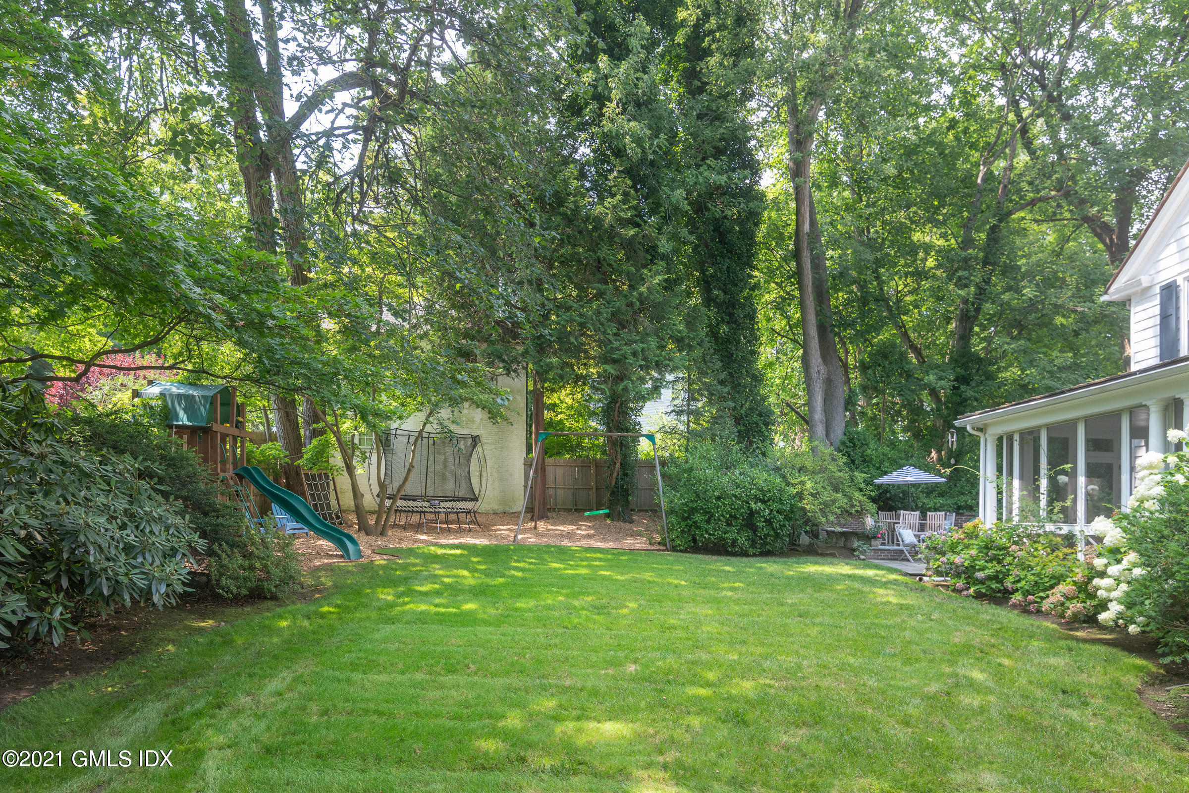 6 Park Avenue Greenwich, CT 06830 - Photo 18 of 24 a view of a house with a backyard