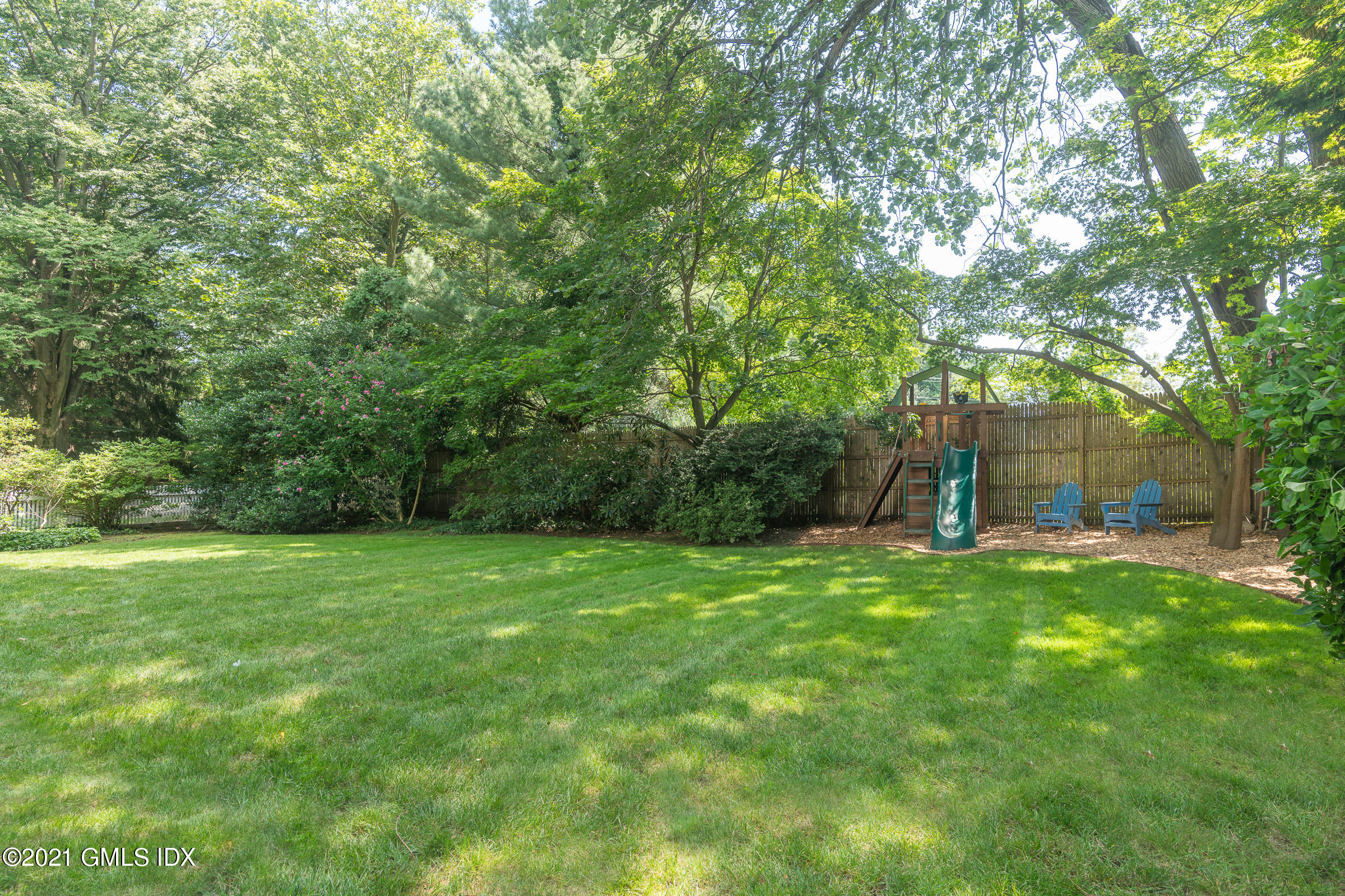 6 Park Avenue Greenwich, CT 06830 - Photo 20 of 24 a view of a big yard with a tree