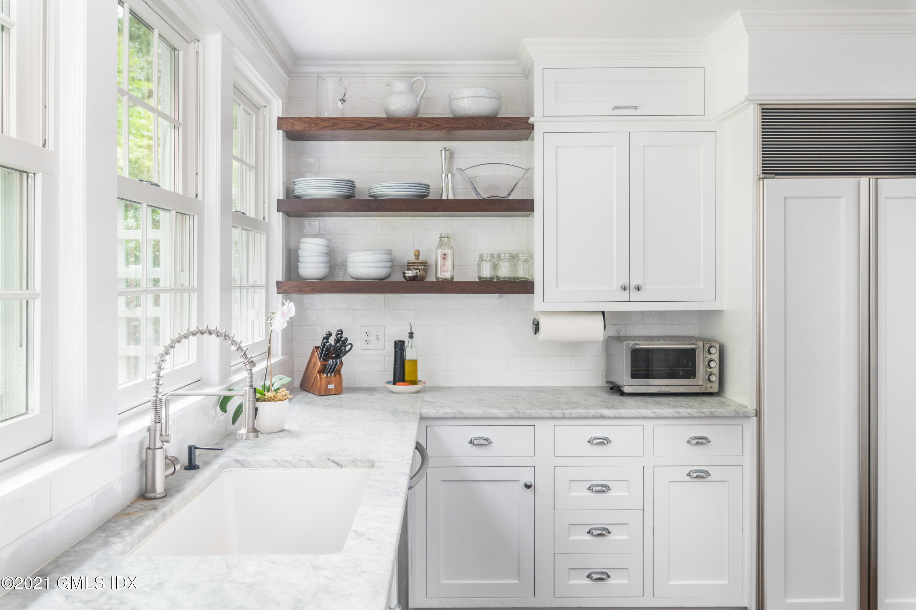 6 Park Avenue Greenwich, CT 06830 - Photo 6 of 24 a kitchen with white cabinets and window