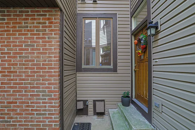 a view of a brick house with a large window