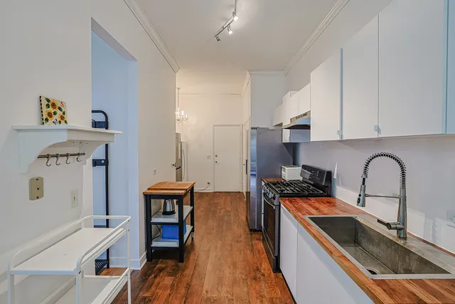 a view of a kitchen with sink and wooden floor