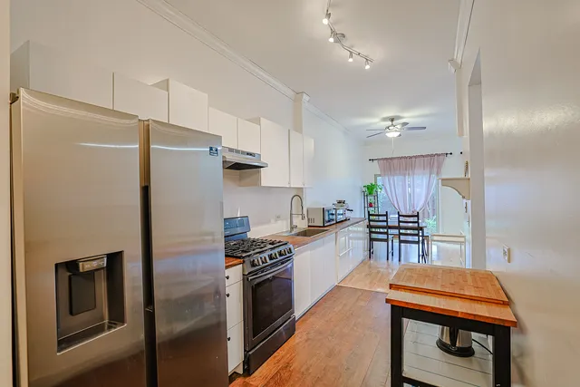 a kitchen with stainless steel appliances a refrigerator stove and sink