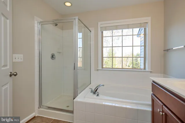 a bathroom with a tub sink and shower