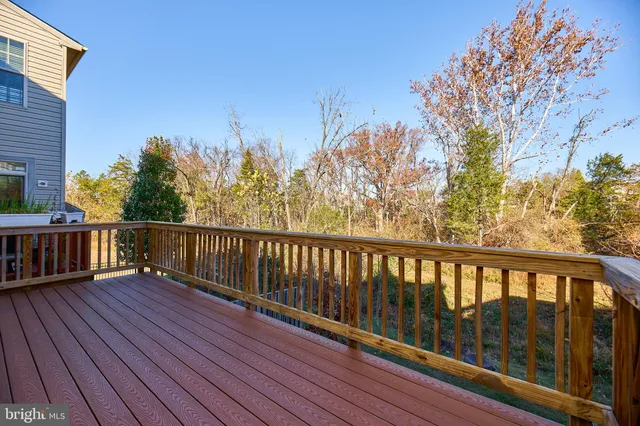 a view of balcony with wooden floor and fence