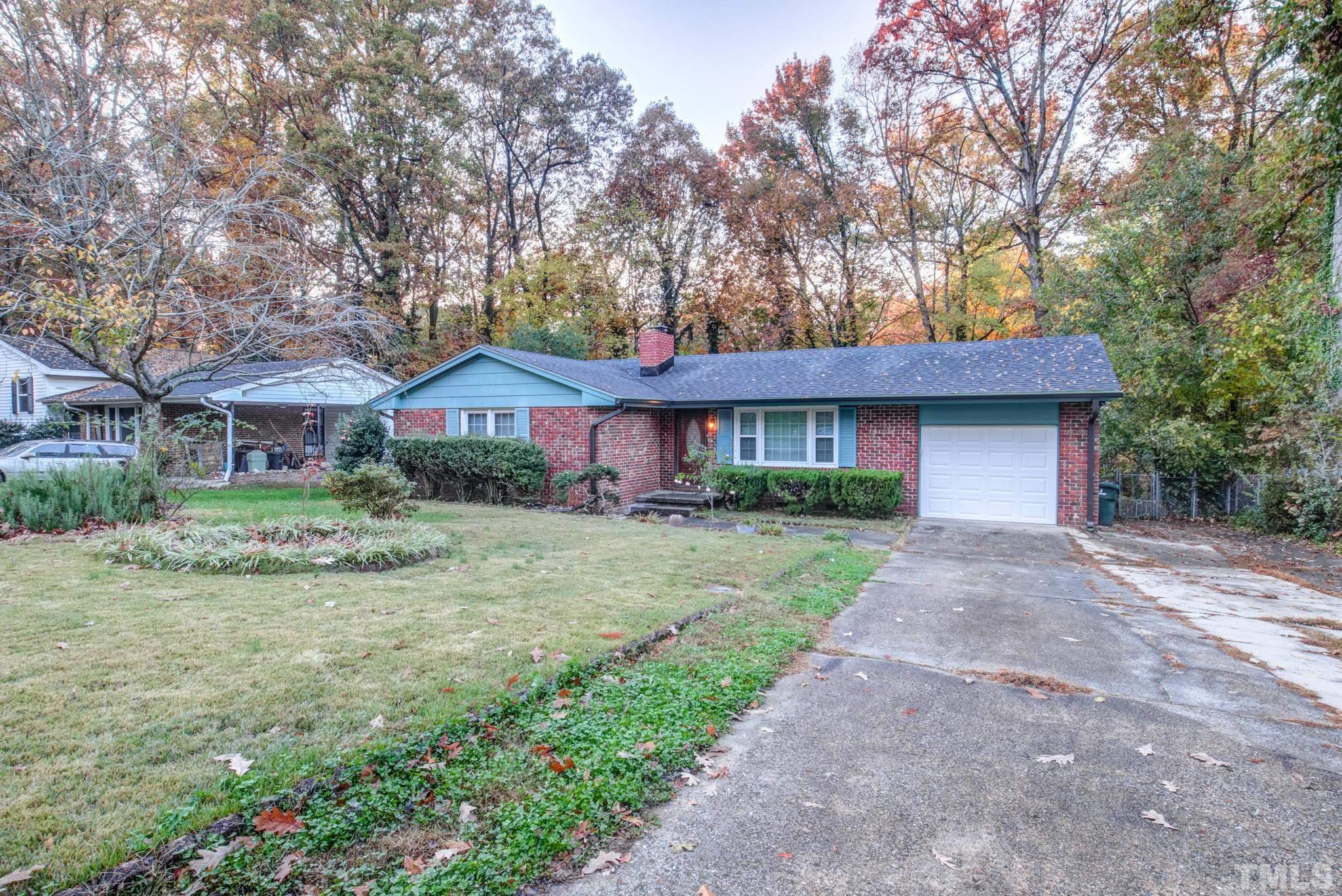 3213 Julian Drive Raleigh, NC 27604 - Photo 2 of 54 a front view of a house with a garden and trees