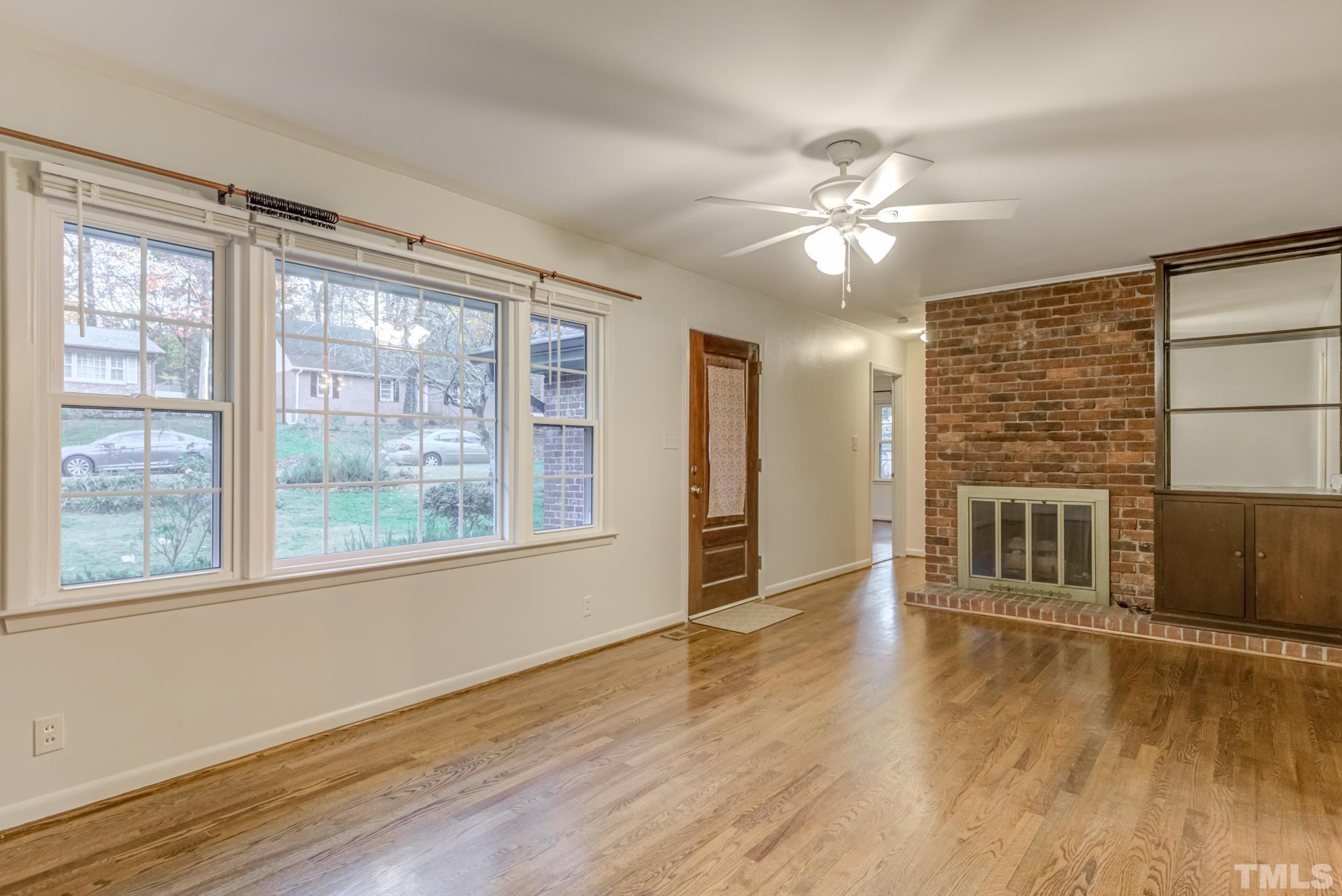 3213 Julian Drive Raleigh, NC 27604 - Photo 12 of 54 a view of an empty room with window and wooden floor