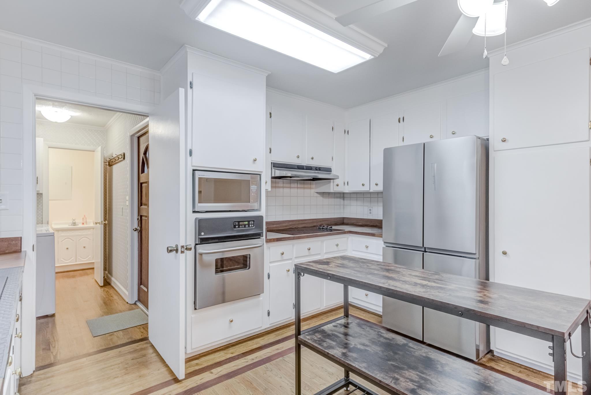 3213 Julian Drive Raleigh, NC 27604 - Photo 21 of 54 a kitchen with stainless steel appliances a refrigerator and a stove top oven