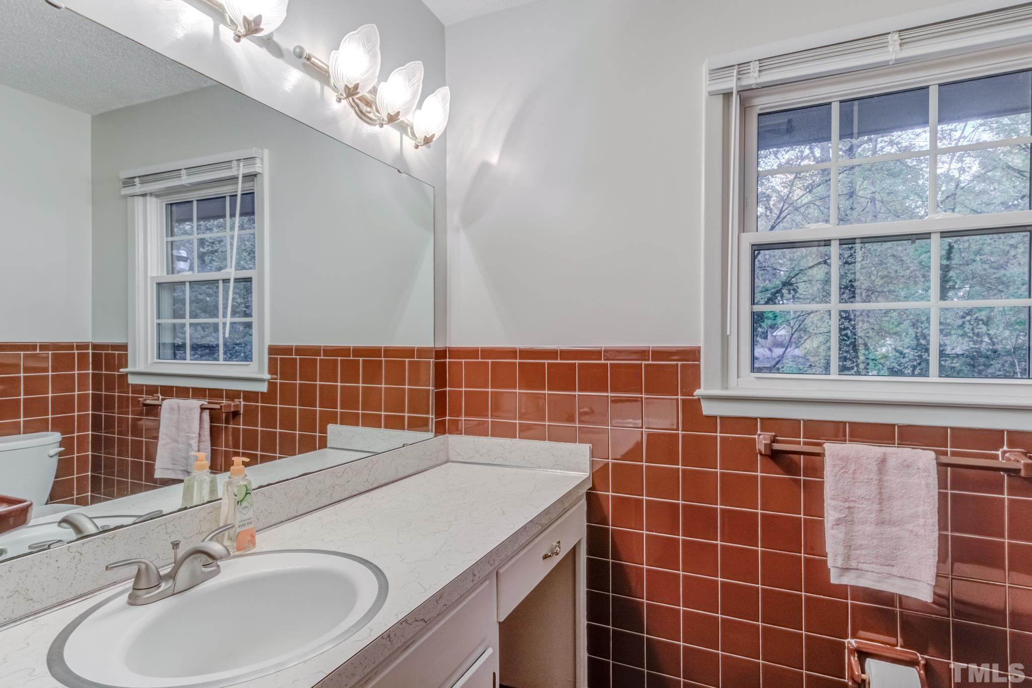3213 Julian Drive Raleigh, NC 27604 - Photo 31 of 54 a bathroom with a double vanity sink and a shower