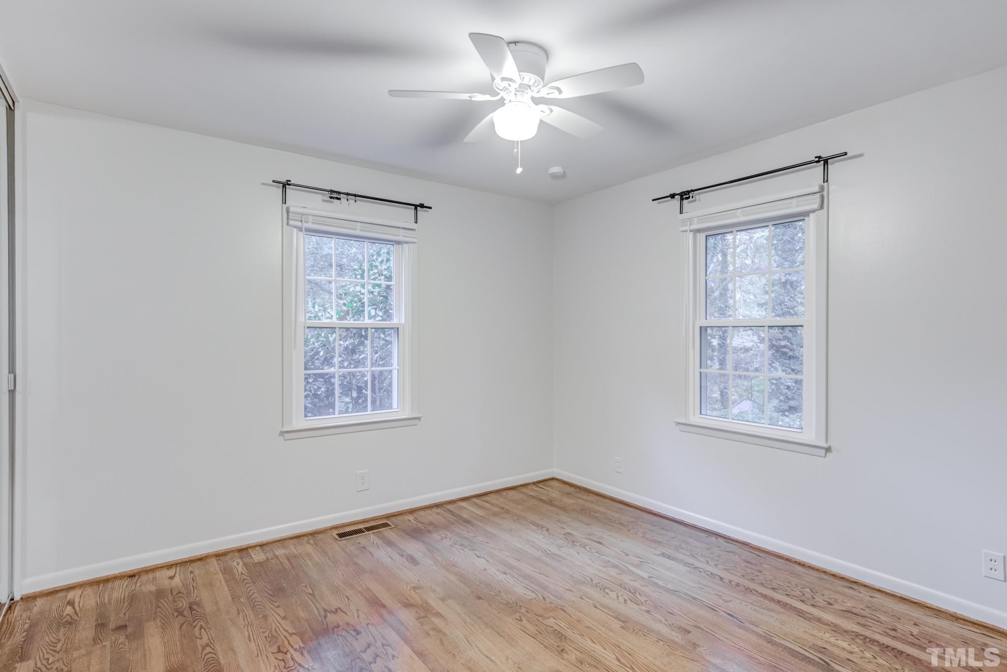 3213 Julian Drive Raleigh, NC 27604 - Photo 33 of 54 a view of an empty room with a window and wooden floor