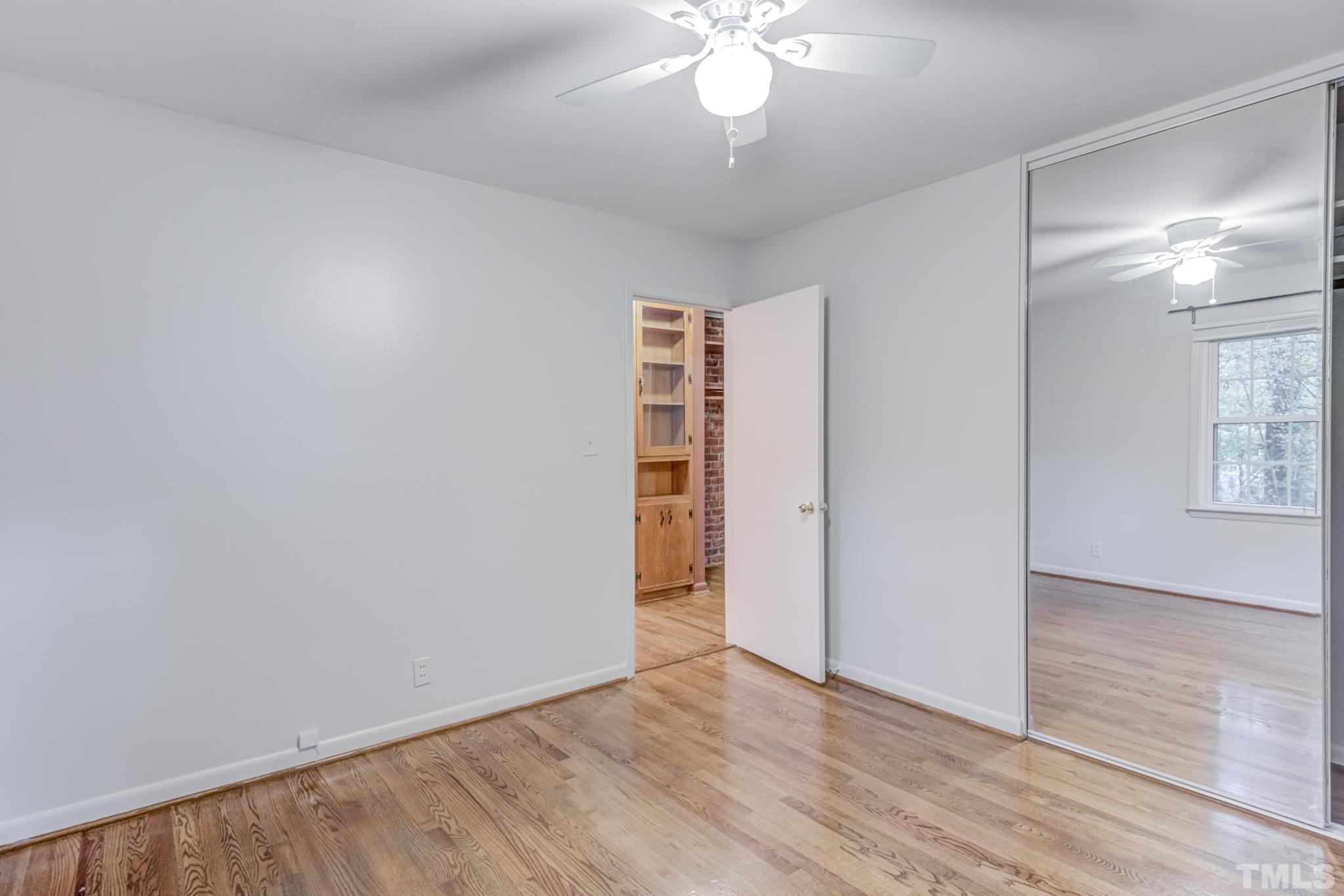 3213 Julian Drive Raleigh, NC 27604 - Photo 34 of 54 an empty room with wooden floor closet and windows