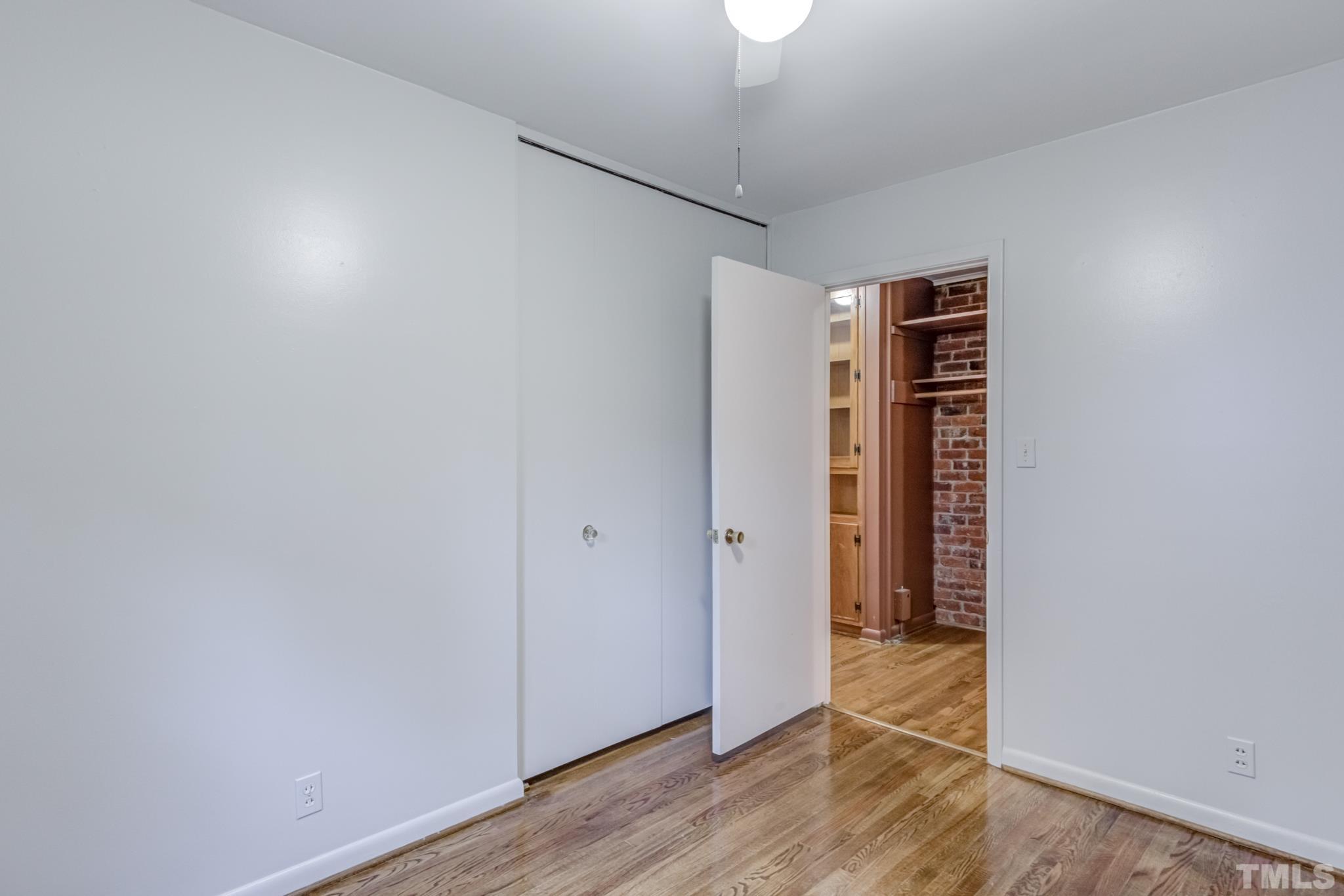 3213 Julian Drive Raleigh, NC 27604 - Photo 37 of 54 an empty room with wooden floor closet and windows