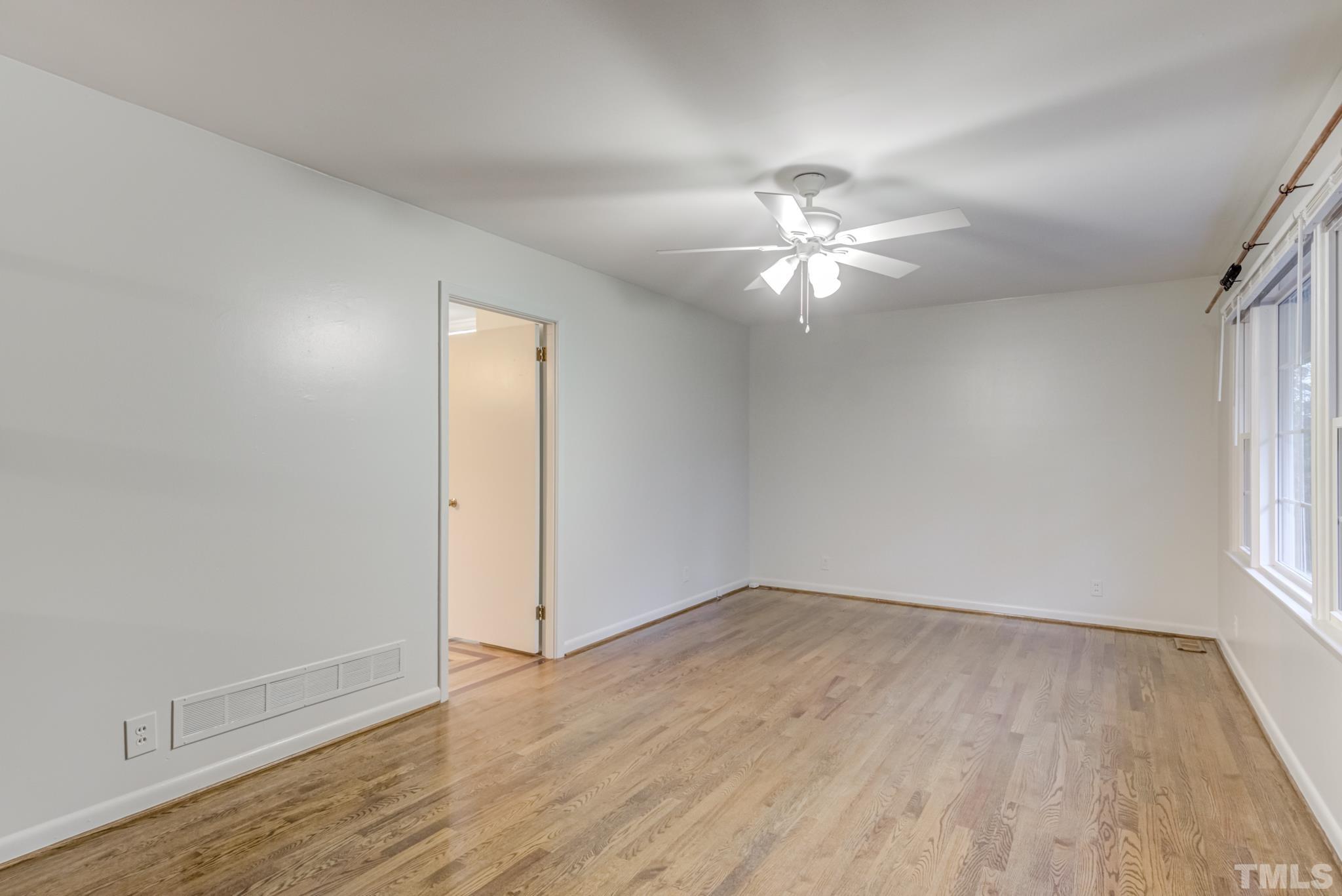 3213 Julian Drive Raleigh, NC 27604 - Photo 10 of 54 wooden floor in an empty room with a window