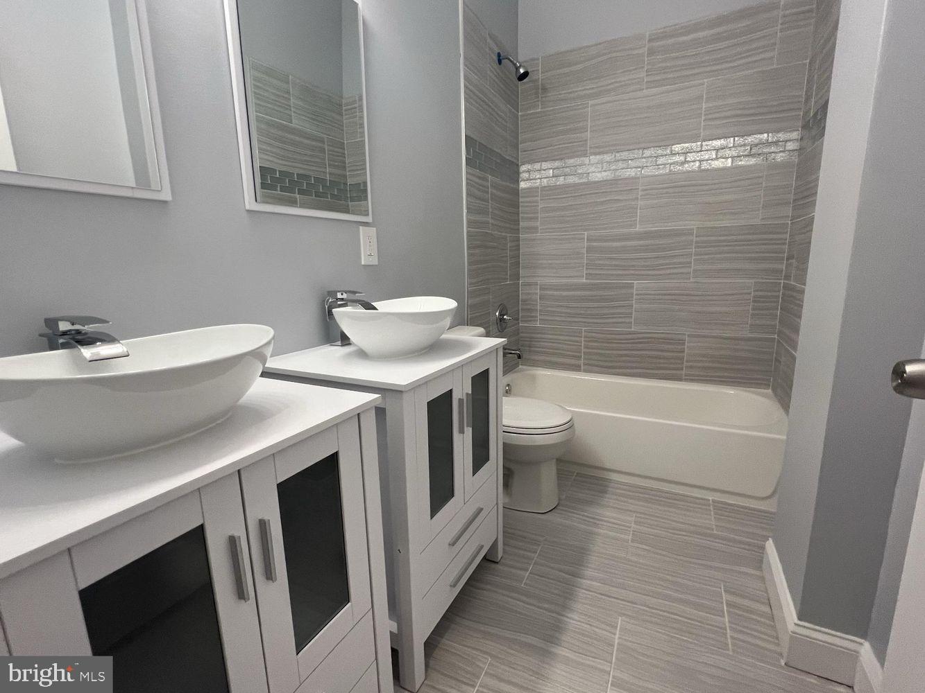 1607 East Biddle Street Baltimore, MD 21213 - Photo 17 of 23 a bathroom with a sink a toilet and shower