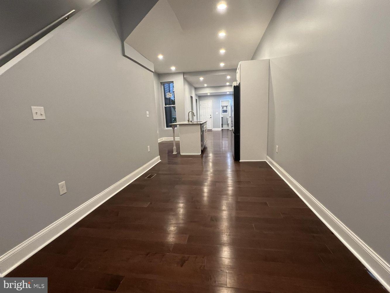 1607 East Biddle Street Baltimore, MD 21213 - Photo 3 of 23 a view of empty room with wooden floor