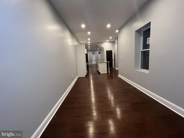 a view of a hallway with wooden floor