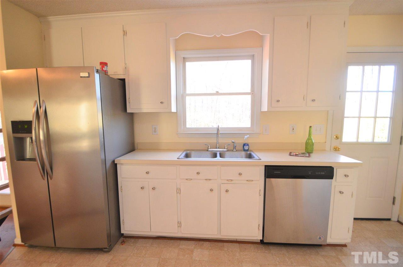 6801 Kiger Road Rougemont, NC 27572 - Photo 11 of 25 a kitchen with a refrigerator sink and cabinets