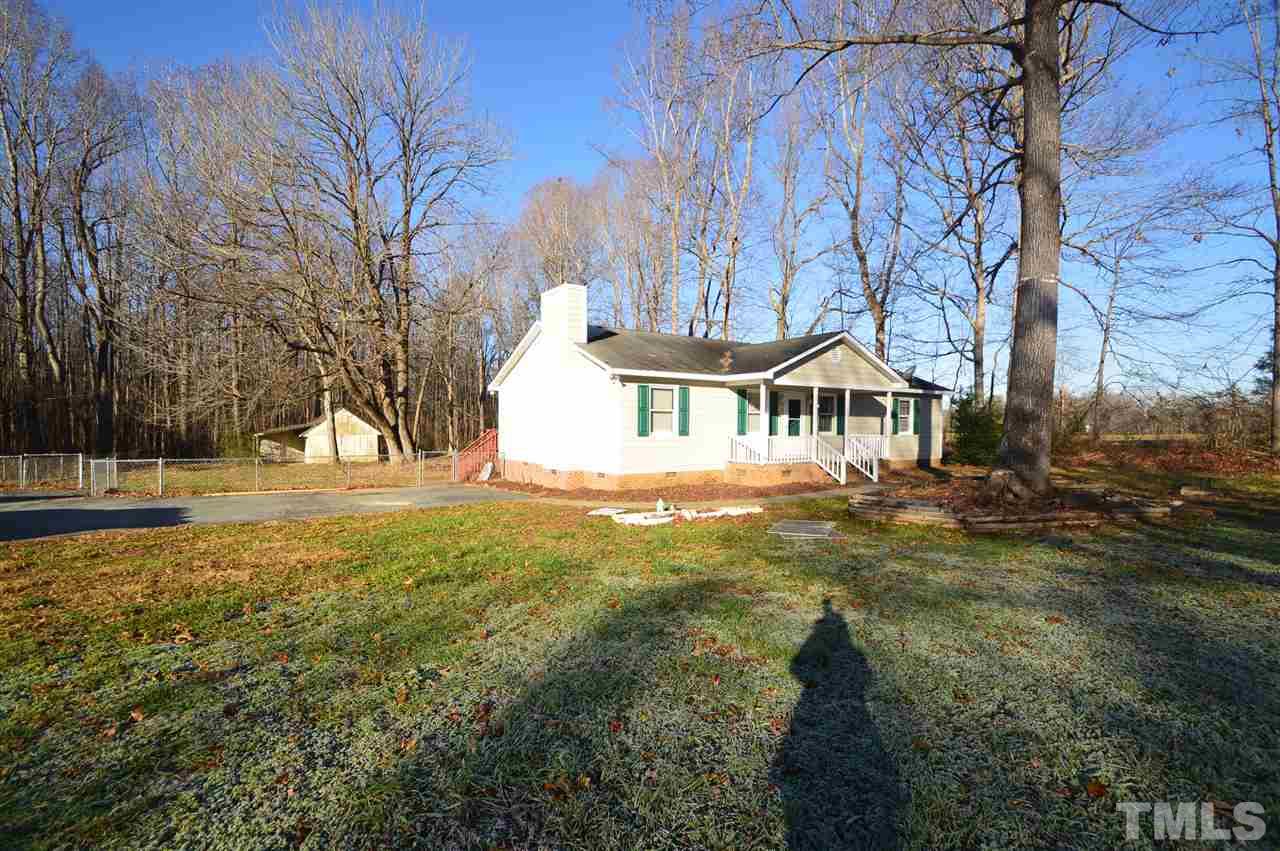 6801 Kiger Road Rougemont, NC 27572 - Photo 23 of 25 a backyard of a house with large trees and outdoor seating