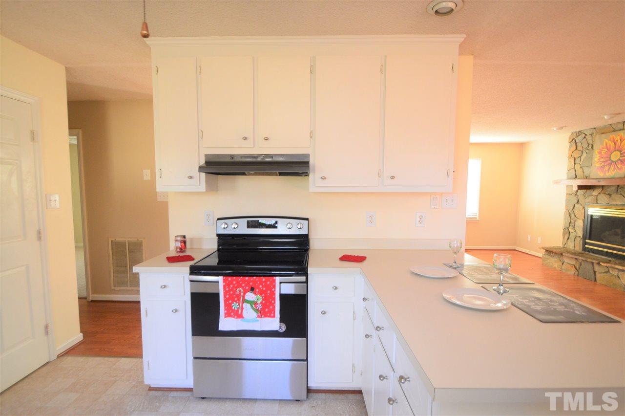 6801 Kiger Road Rougemont, NC 27572 - Photo 10 of 25 a kitchen with stainless steel appliances granite countertop a stove and a sink
