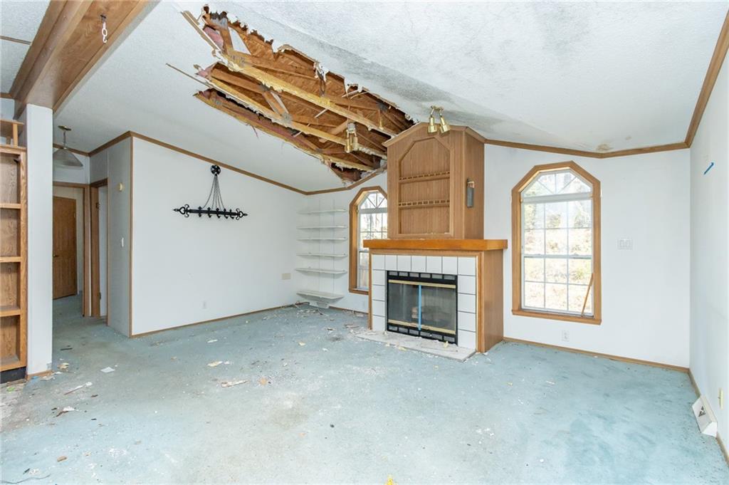 145 Shelby Lane Apollo, PA 15613 - Photo 7 of 21 an empty room with windows fireplace and fans
