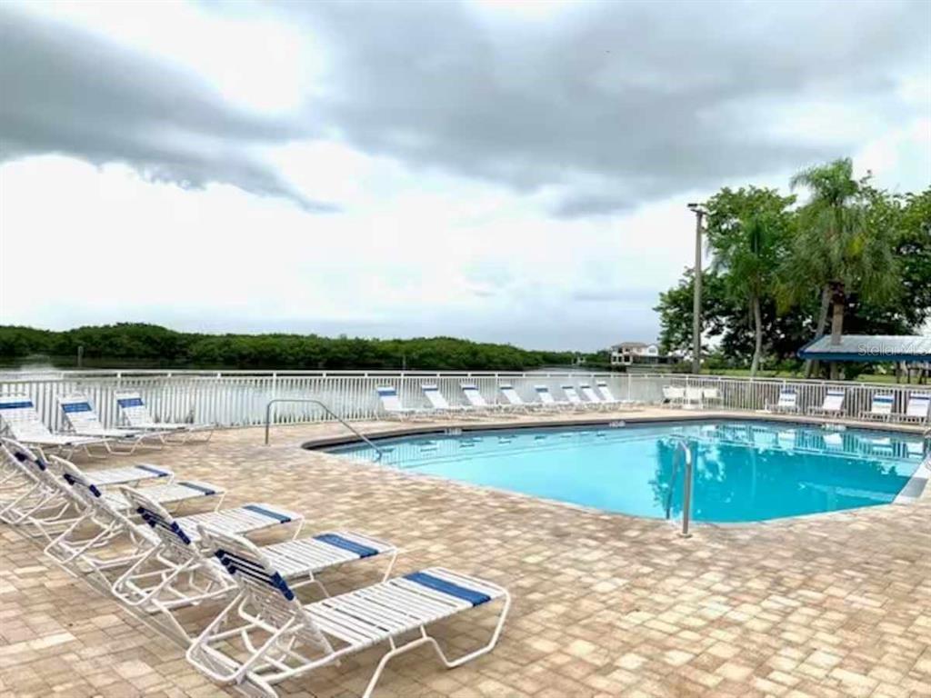 611 Destiny Drive, Unit 101 Ruskin, FL 33570 - Photo 14 of 20 an outdoor space with pool and furniture