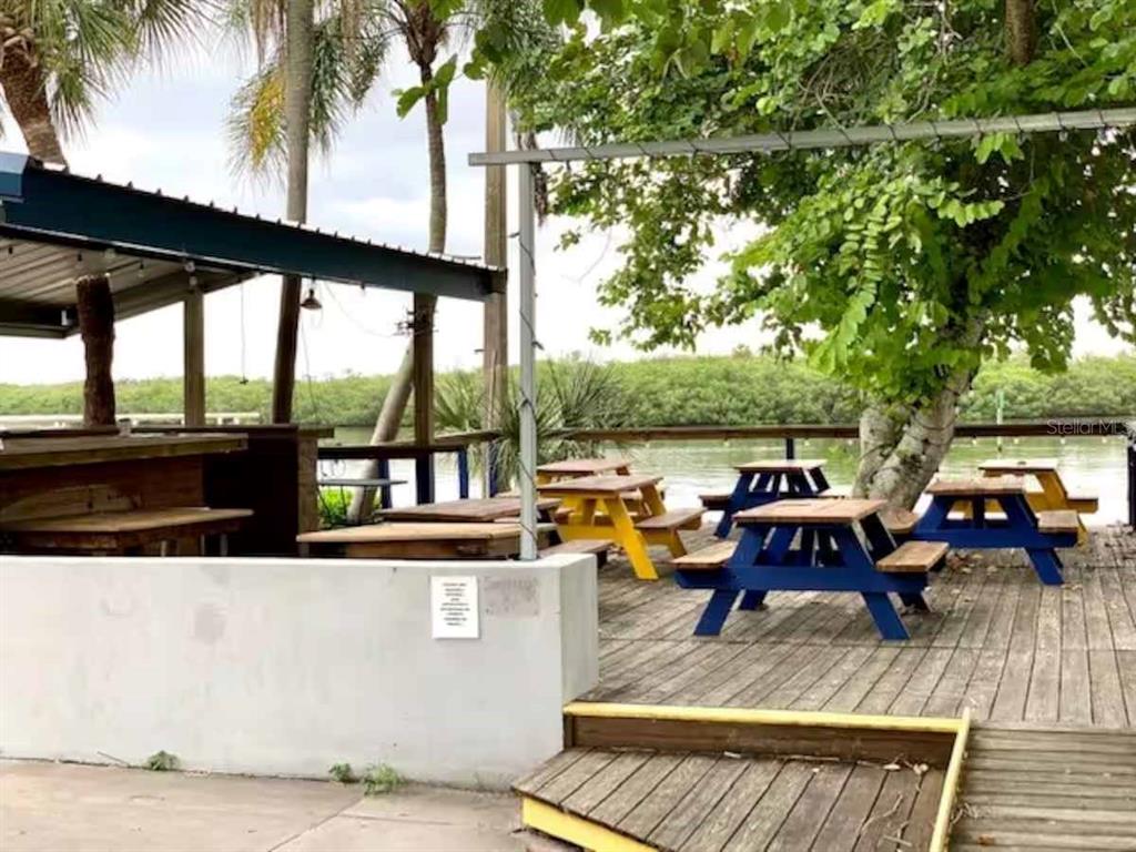 611 Destiny Drive, Unit 101 Ruskin, FL 33570 - Photo 19 of 20 a view of a patio with swimming pool table and chairs