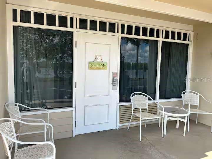 611 Destiny Drive, Unit 101 Ruskin, FL 33570 - Photo 2 of 20 a dinning table and chairs in a balcony