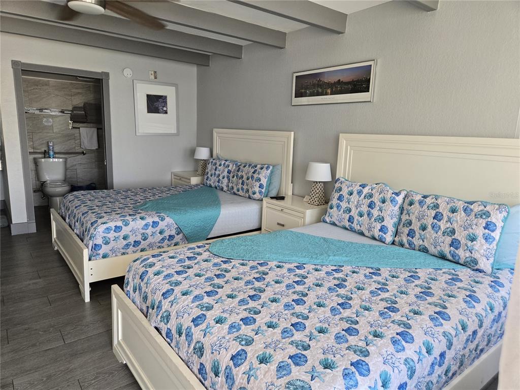 611 Destiny Drive, Unit 101 Ruskin, FL 33570 - Photo 6 of 20 a bedroom with a bed and two lamp on dresser