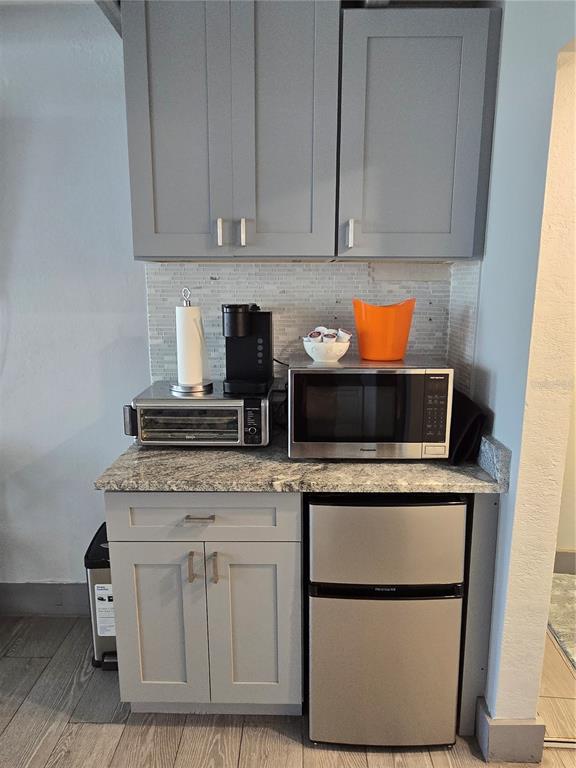 611 Destiny Drive, Unit 101 Ruskin, FL 33570 - Photo 8 of 20 a kitchen with white cabinets and appliances