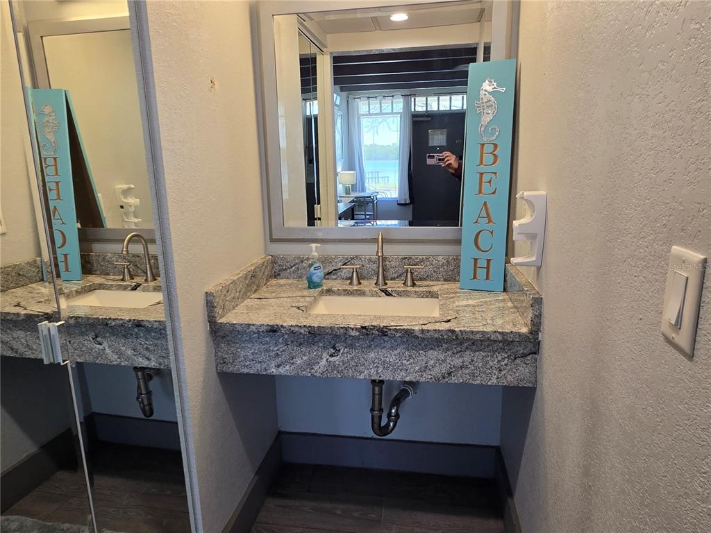 611 Destiny Drive, Unit 101 Ruskin, FL 33570 - Photo 9 of 20 a bathroom with a granite countertop sink and a mirror
