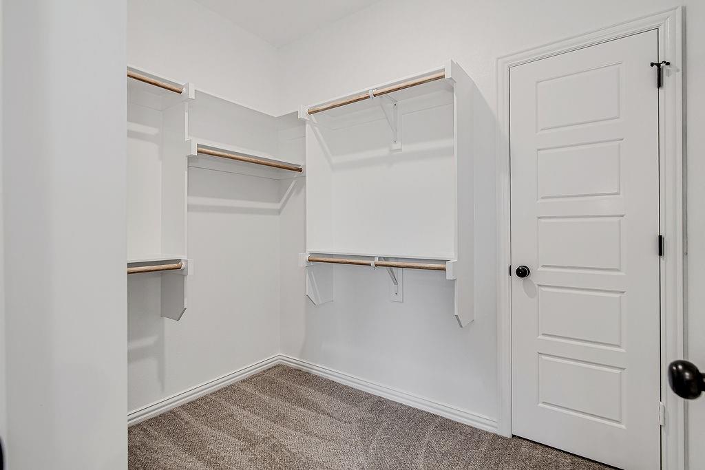 1520 Whippoorwill Way Azle, TX 76020 - Photo 18 of 25 a view of walk in closet with empty racks