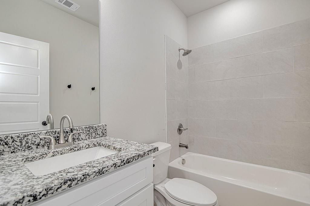 1520 Whippoorwill Way Azle, TX 76020 - Photo 21 of 25 a bathroom with a granite countertop sink toilet and shower