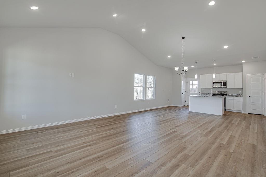 1520 Whippoorwill Way Azle, TX 76020 - Photo 7 of 25 a view of kitchen with kitchen island wooden floor stainless steel appliances and cabinets