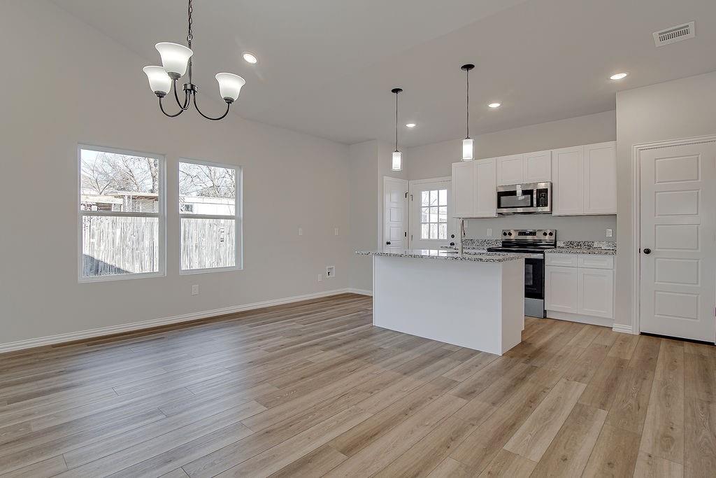 1520 Whippoorwill Way Azle, TX 76020 - Photo 10 of 25 a view of a kitchen with granite countertop stainless steel appliances and wooden floor