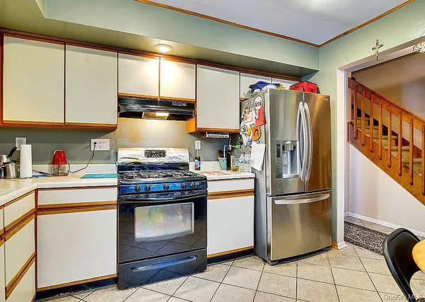 a kitchen with a stove top oven and sink
