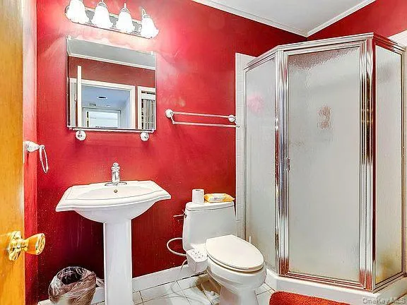 a bathroom with a sink mirror toilet and shower