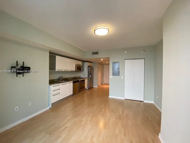 a kitchen with granite countertop a stove and cabinets