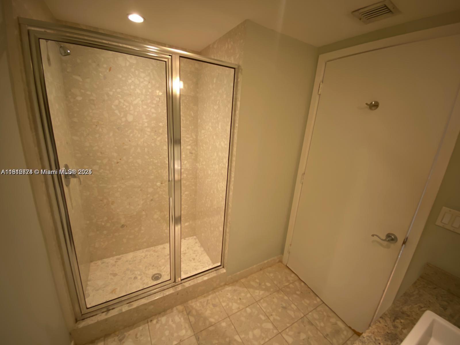 185 Southwest 7th Street, Unit 3306 Miami, FL 33130 - Photo 6 of 8 a bathroom with a glass door shower