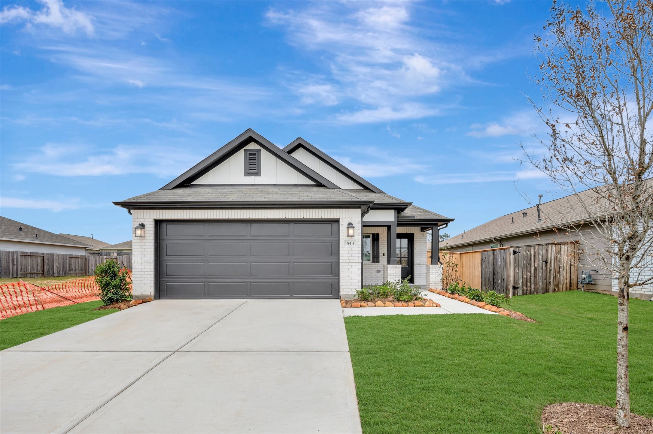 543 Flower Reed Court Magnolia, TX 77354 - Photo 12 of 46 a front view of a house with a yard and garage
