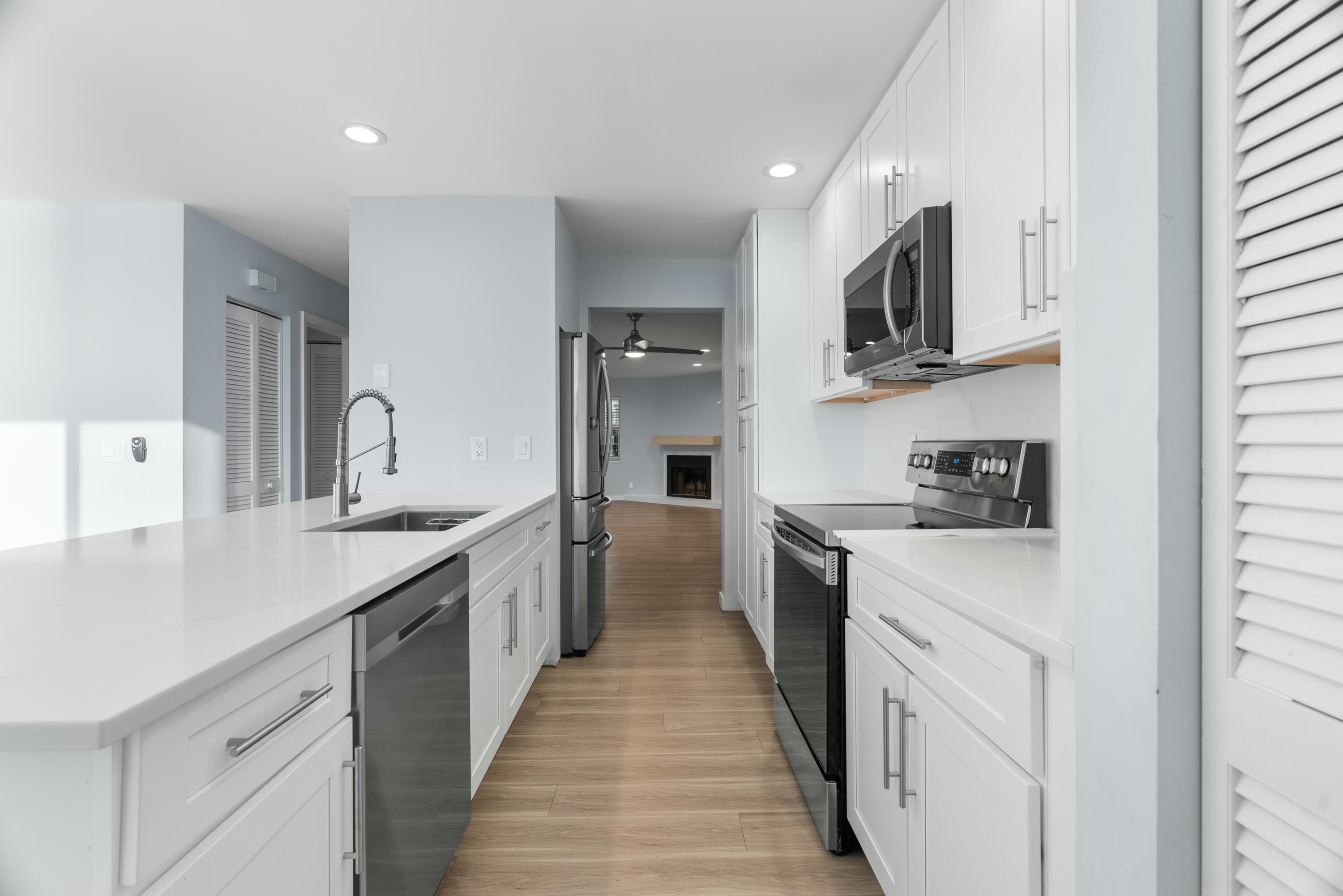 210 Ocean Dunes Circle Jupiter, FL 33477 - Photo 20 of 43 a large kitchen with stainless steel appliances granite countertop a lot of counter space and a sink